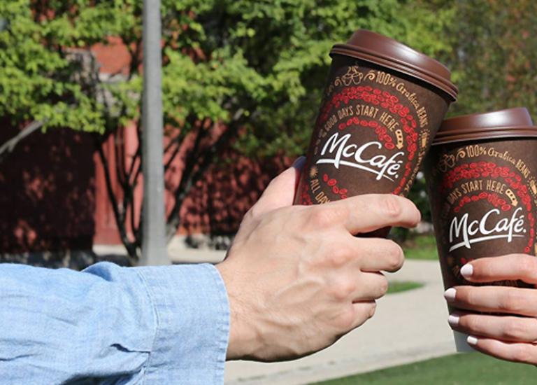 People toasting with Double-walled McCafe Hot Cups