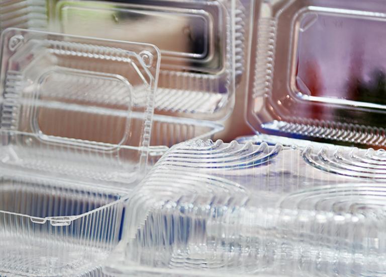stack of clear plastic clamshell packaging